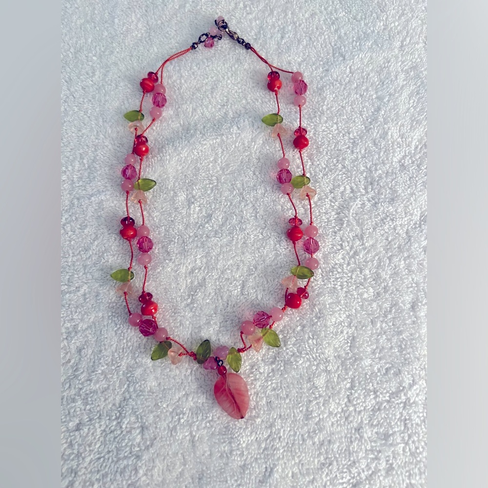 Glass bead necklace. Green leaves, pink glass and stone beads. 18” long.